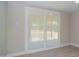 Living room features sliding glass door, blinds, light walls, and plank flooring at 3249 E Sunnyside Ln, Phoenix, AZ 85032