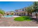 Expansive backyard with lush landscaping, a sparkling pool, and a covered patio area at 3574 E Glacier Pl, Chandler, AZ 85249