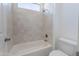 Bright bathroom with a tiled shower over the bathtub and a white toilet at 3574 E Glacier Pl, Chandler, AZ 85249