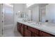 Bathroom with double sinks and a marble countertop, with access to the toilet and shower at 3574 E Glacier Pl, Chandler, AZ 85249