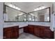 Elegant bathroom with double vanity, granite countertops, large mirrors, and ample storage at 3574 E Glacier Pl, Chandler, AZ 85249