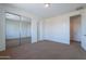 Spacious bedroom with a mirrored closet and a door to an additional room at 3574 E Glacier Pl, Chandler, AZ 85249