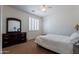 Bedroom with plantation shutters, ceiling fan and brown carpet at 3574 E Glacier Pl, Chandler, AZ 85249