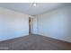A simple bedroom with neutral colors, carpeted floors and an attached bathroom at 3574 E Glacier Pl, Chandler, AZ 85249