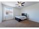 Bedroom with natural light, carpeted floor and a ceiling fan above the bed at 3574 E Glacier Pl, Chandler, AZ 85249