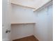 Walk-in closet with wood shelving and carpeted floor at 3574 E Glacier Pl, Chandler, AZ 85249
