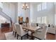 A spacious dining area featuring hardwood floors, a modern chandelier, and large windows at 3574 E Glacier Pl, Chandler, AZ 85249