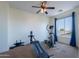 Brightly lit exercise room featuring a ceiling fan, carpet floors, and large window with scenic views at 3574 E Glacier Pl, Chandler, AZ 85249