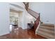 Grand foyer showcasing a curved staircase, wood floors, and elegant details at 3574 E Glacier Pl, Chandler, AZ 85249