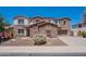 Charming two-story home with stone accents, a well-manicured lawn, and a welcoming two car garage at 3574 E Glacier Pl, Chandler, AZ 85249
