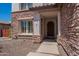 Inviting front porch with stone accents and an arched wood door at 3574 E Glacier Pl, Chandler, AZ 85249