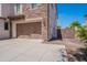 This home features a spacious two-car garage and concrete driveway, complemented by beautiful stone accents on the exterior at 3574 E Glacier Pl, Chandler, AZ 85249