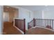 Bright hallway with decorative wooden railing and neutral carpeting at 3574 E Glacier Pl, Chandler, AZ 85249