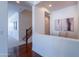 Bright hallway featuring hardwood floors, stairs, and a cozy built-in desk area with natural light at 3574 E Glacier Pl, Chandler, AZ 85249