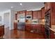 Well-equipped kitchen with built-in microwave, double ovens, and granite countertops at 3574 E Glacier Pl, Chandler, AZ 85249