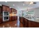 Gourmet kitchen featuring stainless oven and granite island with stainless steel sink at 3574 E Glacier Pl, Chandler, AZ 85249