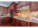 Gourmet kitchen featuring a cooktop and granite counters at 3574 E Glacier Pl, Chandler, AZ 85249
