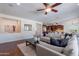 Spacious living room with hardwood floors and an open layout to the kitchen at 3574 E Glacier Pl, Chandler, AZ 85249
