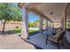 Relaxing covered patio overlooking the well-manicured backyard and sparkling pool at 3574 E Glacier Pl, Chandler, AZ 85249