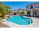 Sparkling swimming pool with rock feature, surrounded by lush greenery and a beautiful backyard at 3574 E Glacier Pl, Chandler, AZ 85249