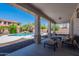 Inviting backyard oasis featuring a covered patio, refreshing pool, and lush landscaping at 3574 E Glacier Pl, Chandler, AZ 85249