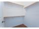 Walk-in closet with shelving and wooden racks for clothes and storage at 3574 E Glacier Pl, Chandler, AZ 85249