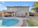 An in-ground pool, patio seating, and covered outdoor living space in the backyard of this home at 4093 E Dublin St, Gilbert, AZ 85295