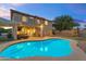 Inviting backyard showcasing a sparkling pool, covered patio, and lush green lawn perfect for outdoor entertaining at 4093 E Dublin St, Gilbert, AZ 85295