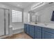 Bright bathroom featuring double sinks, a tub, and a shower with glass enclosure at 4093 E Dublin St, Gilbert, AZ 85295