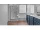 Bathroom featuring double sinks, a tub, and a separate shower with glass enclosure at 4093 E Dublin St, Gilbert, AZ 85295