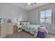 Comfortable bedroom with a window, dresser, and decorative accents at 4093 E Dublin St, Gilbert, AZ 85295