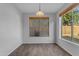Inviting dining room area with a large window overlooking the backyard and simple modern lighting at 4093 E Dublin St, Gilbert, AZ 85295