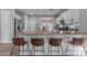 Stylish kitchen with white cabinets, a large island with barstool seating, and modern stainless steel appliances at 4093 E Dublin St, Gilbert, AZ 85295