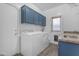 Functional laundry room with washer, dryer, sink, and storage cabinets at 4093 E Dublin St, Gilbert, AZ 85295