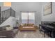 Stylish living room with comfortable seating, a piano, and a staircase, creating a cozy ambiance at 4093 E Dublin St, Gilbert, AZ 85295