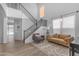 Open-concept living room with a staircase, large windows, and contemporary furnishings at 4093 E Dublin St, Gilbert, AZ 85295