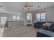 Cozy loft area with a soft carpet, fan, and a navy sectional, creating an inviting atmosphere at 4093 E Dublin St, Gilbert, AZ 85295