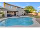 An in-ground pool with seating area and a play structure in the spacious backyard of this two-story home at 4093 E Dublin St, Gilbert, AZ 85295