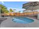 Sparkling pool with patio space, complemented by a playset in the backyard at 4093 E Dublin St, Gilbert, AZ 85295