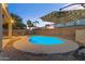 Backyard oasis featuring a lit pool, playset, and comfortable seating for evening enjoyment at 4093 E Dublin St, Gilbert, AZ 85295