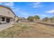 Large backyard with a patio area, desert landscaping, and perimeter fencing, perfect for outdoor living at 43271 W Little Dr, Maricopa, AZ 85138