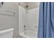 Bright bathroom featuring a shower-tub combination and a blue shower curtain at 43271 W Little Dr, Maricopa, AZ 85138