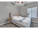 This bedroom is serene, with a upholstered bed, soft carpet, and natural light from the window at 43271 W Little Dr, Maricopa, AZ 85138