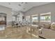 Open living space with a dining area and a comfortable sectional sofa, perfect for relaxing or entertaining at 43271 W Little Dr, Maricopa, AZ 85138