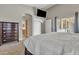 Comfortable main bedroom featuring carpet flooring, patio access, and a glimpse of the bathroom at 43271 W Little Dr, Maricopa, AZ 85138
