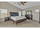 The main bedroom has a ceiling fan, carpet floors, and a complete furniture set at 43271 W Little Dr, Maricopa, AZ 85138