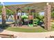 Community playground with slides and climbing area, offering a safe and engaging space for children near the pond at 43271 W Little Dr, Maricopa, AZ 85138