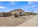 Side view of the home featuring desert landscaping, a fenced yard, and a well-maintained exterior at 43271 W Little Dr, Maricopa, AZ 85138