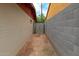 Backyard walkway featuring a storage shed between neighboring block walls and homes at 4333 E Desert Cactus St, Phoenix, AZ 85032