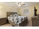 Bedroom with a cozy bed, shuttered windows, ceiling fan, and neutral toned decor at 4333 E Desert Cactus St, Phoenix, AZ 85032